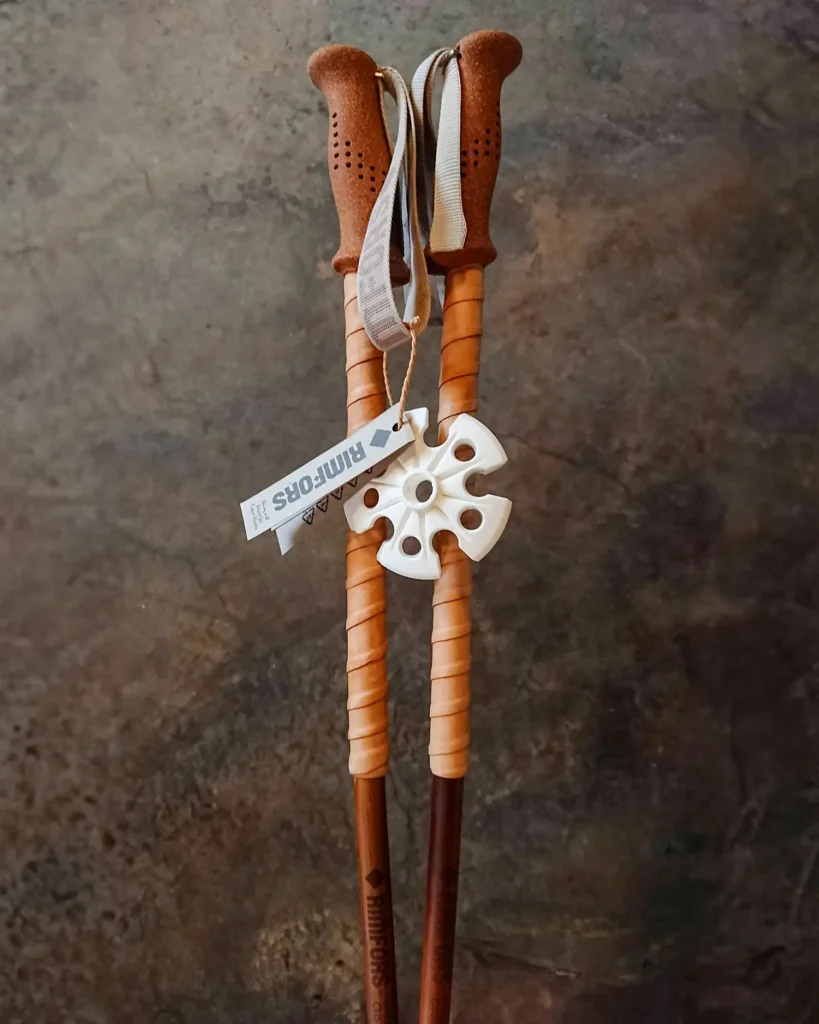 Dark tan bamboo ski poles with reindeer grip extensions.