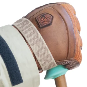 Hand with brown leather glove holding a bamboo ski pole with beige strap with the text Rimfors on.