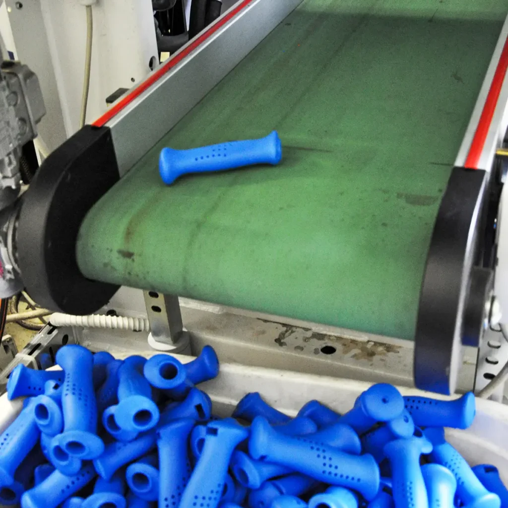 Fresh blue grips (FK1522/E) coming out of the Arburg Allr molding machine.