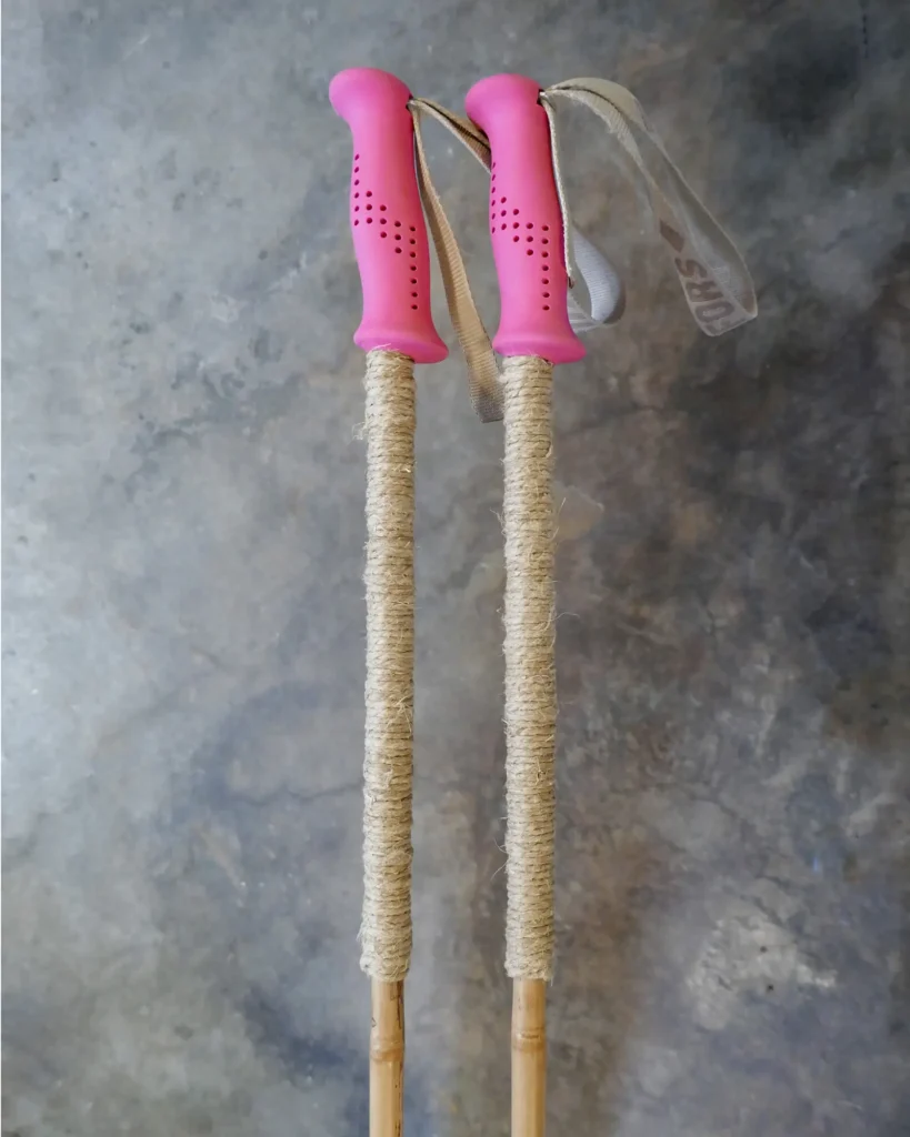 Bamboo ski poles with pink grips and extended grips made from wrapped hemp cord.