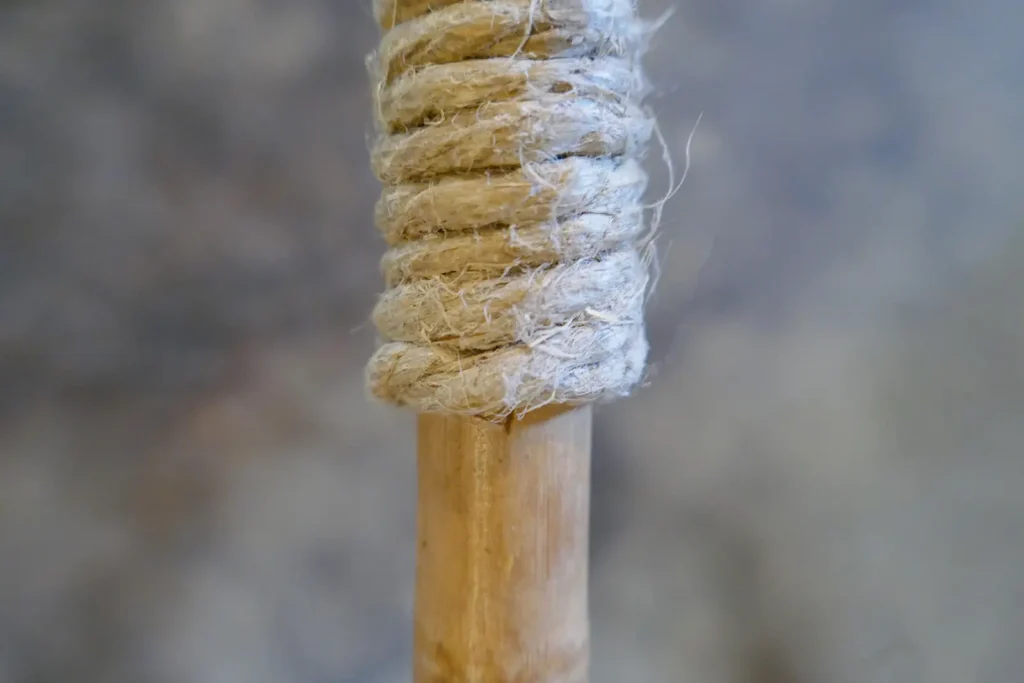 Close-up of bamboo ski pole with wrapped hemp twine.