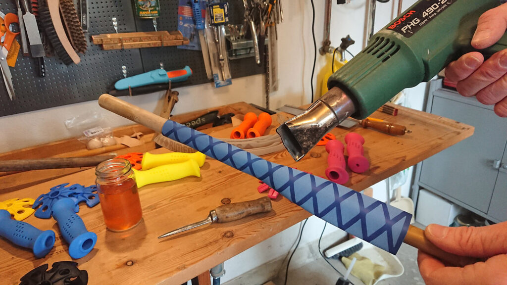 Grip extension using non-slip heat shrink tubing is attached to the bamboo ski poles with a heat gun.