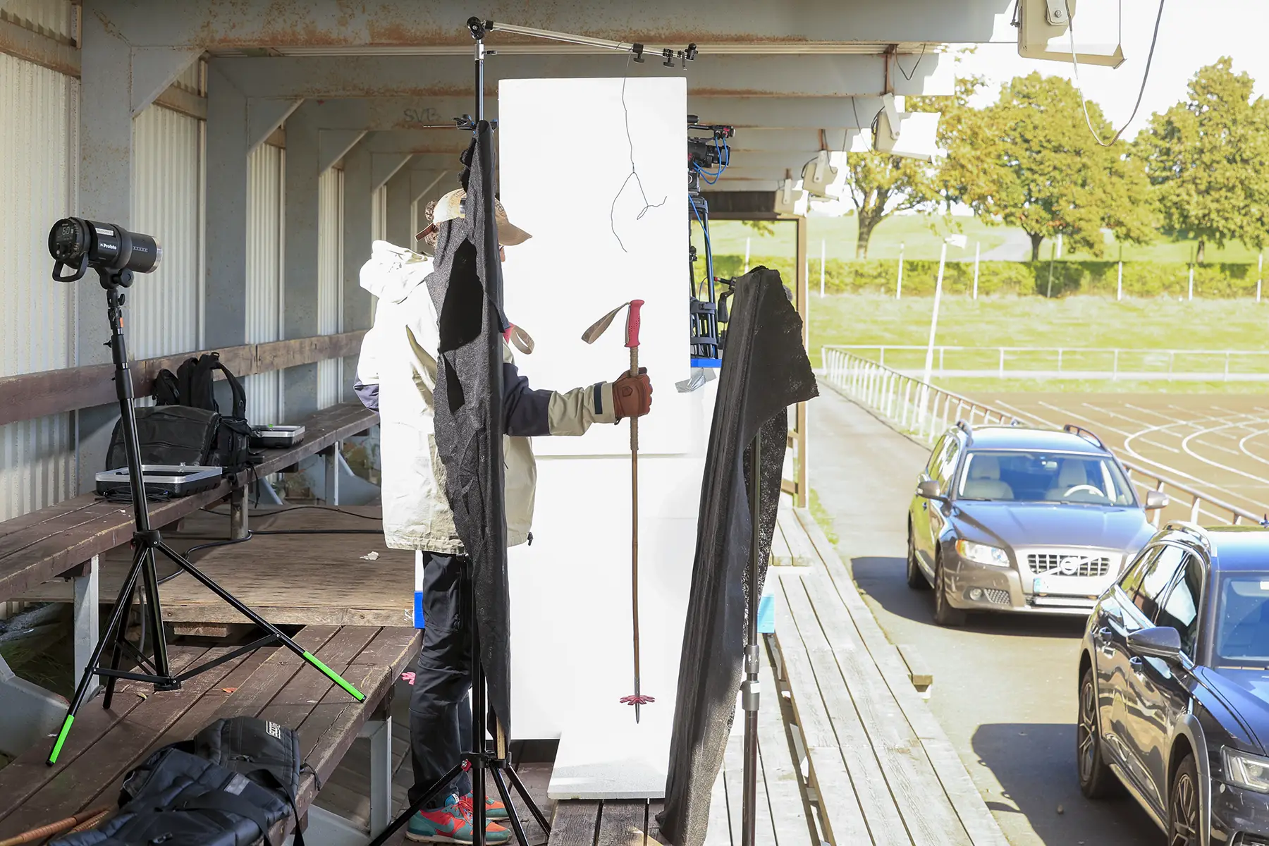 Fabian Rimfors holds a bamboo ski pole to be photographed in our pop-up photo studio built on the grandstands at Simrishamns sports ground.