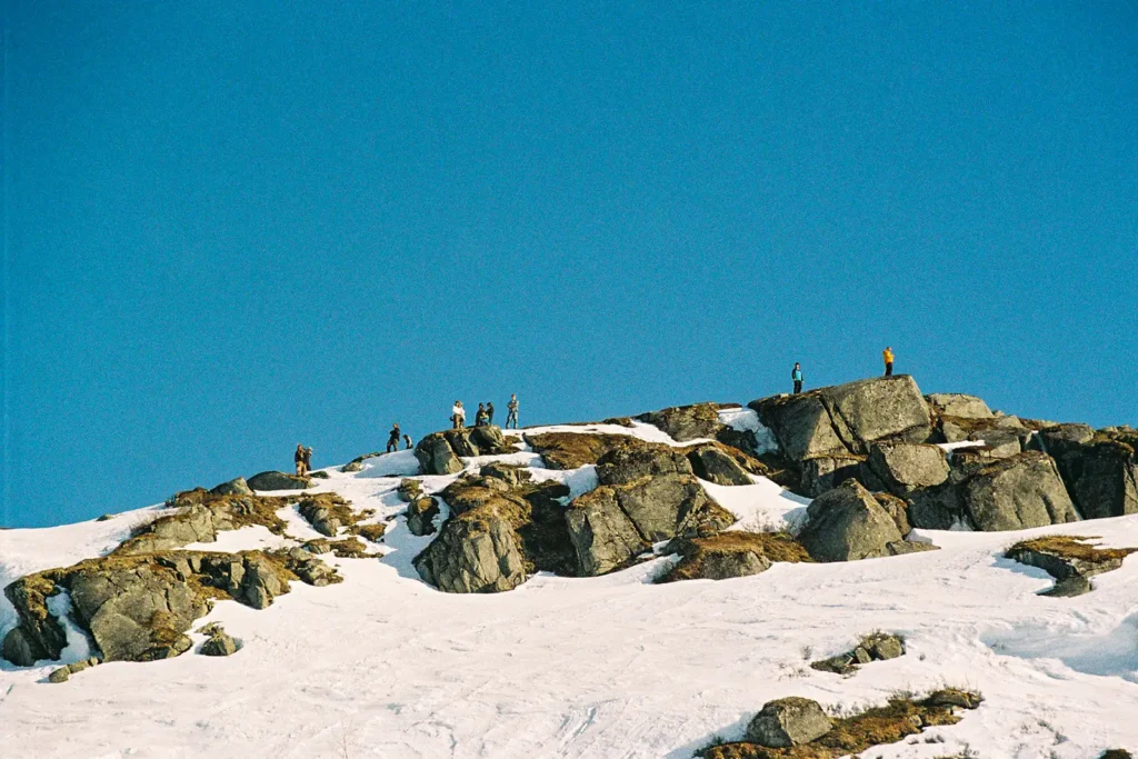 Freeride skiers scouting the competition terrain with cliffs and snow during Rimfors Open.