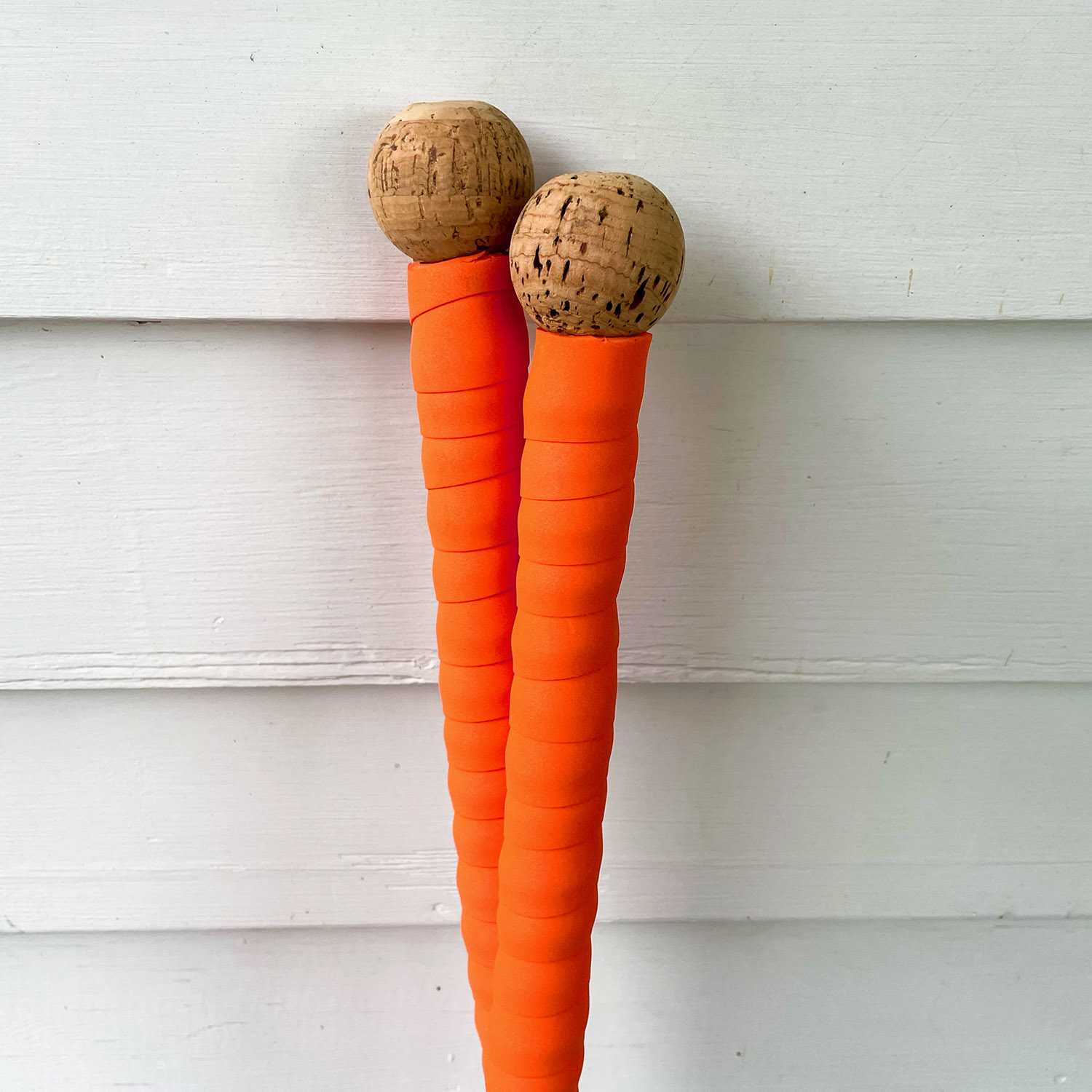 Backcountry touring poles with grip extensions of orange handlebar tape, crowned with cork balls via glued-in wood dowels.