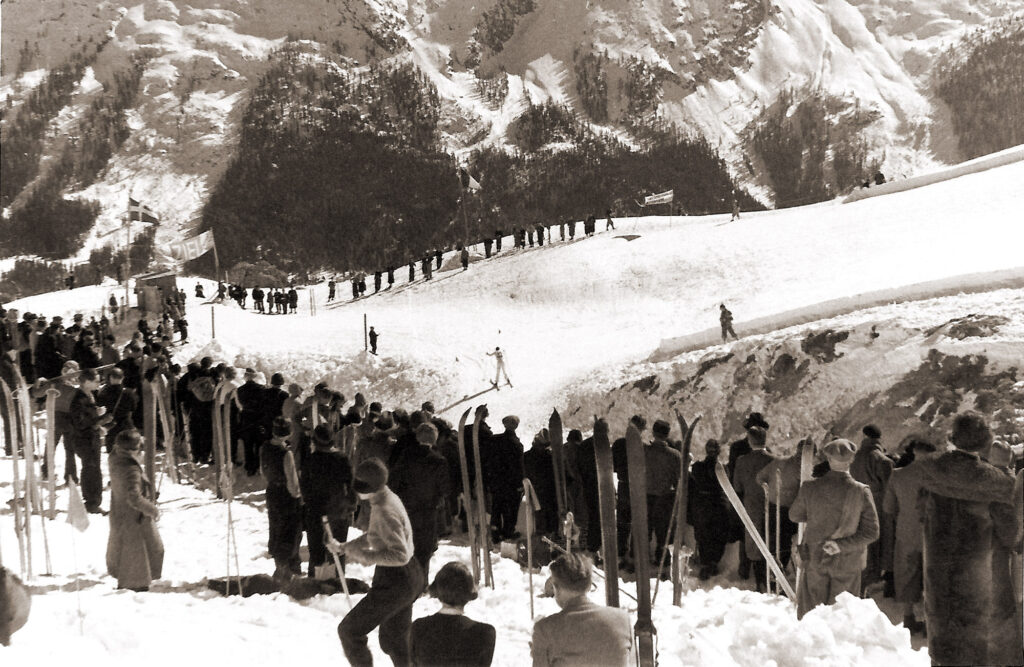 Spanish prince Álvaro de Orléans-Borbón has just passed the ravine and is pushing himself through the last “Kandahar gate” before the finish during the mens' slalom at the FIS Alpine Ski World Championships 1934.